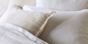a white bed with white sheets