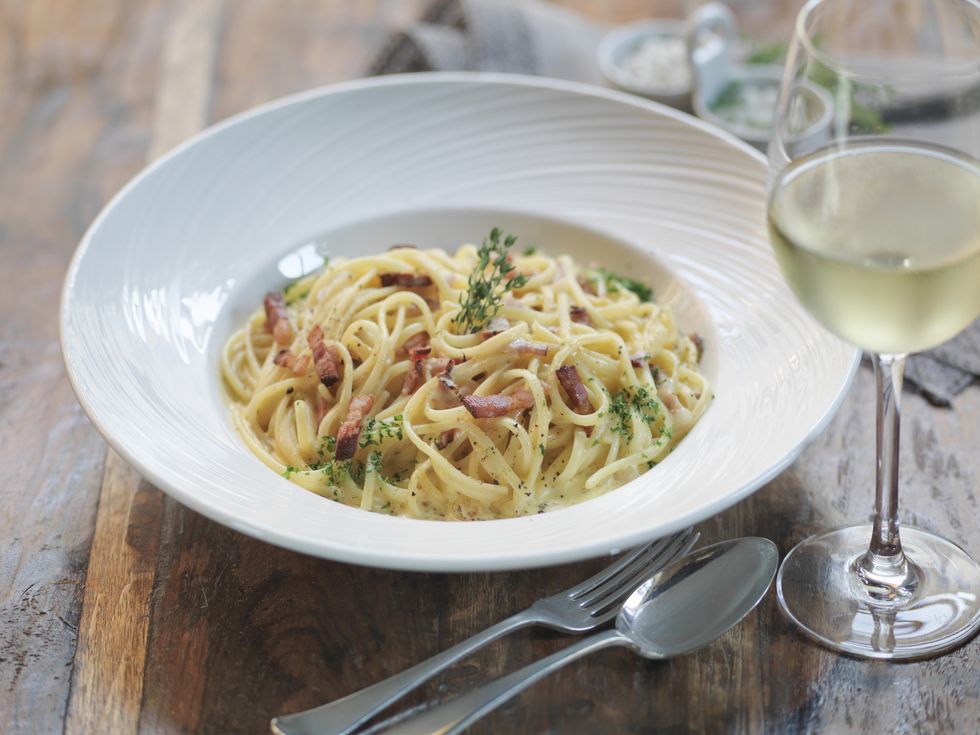 Linguini carbonara made with smoked pancetta, fresh eggs, nutmeg, cream, parmesan cheese and black pepper