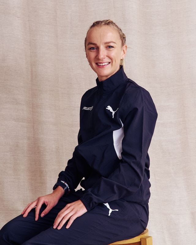 a person seated while wearing a puma tracksuit