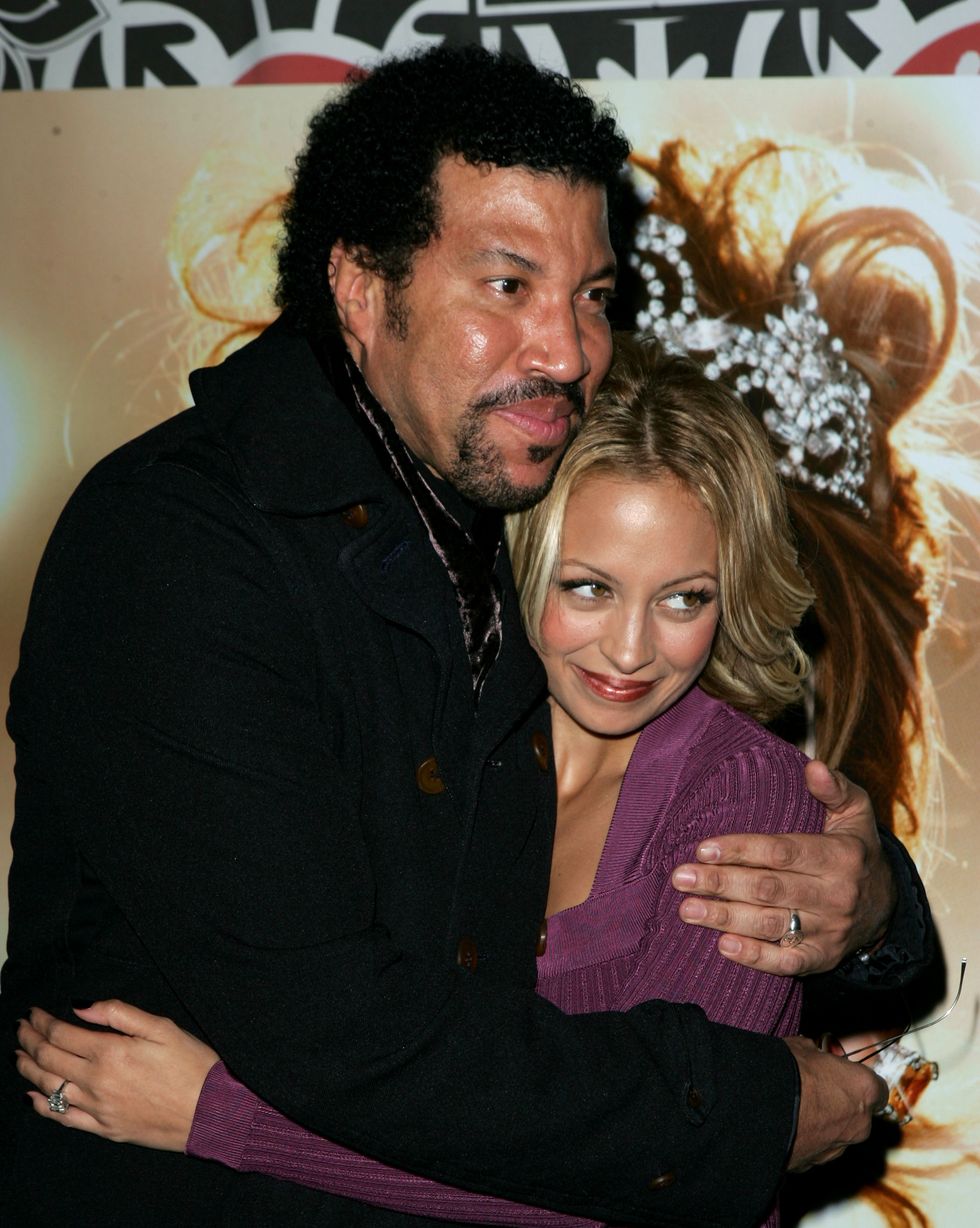 lionel richie and nicole richie hug and smile as they look away from the photo
