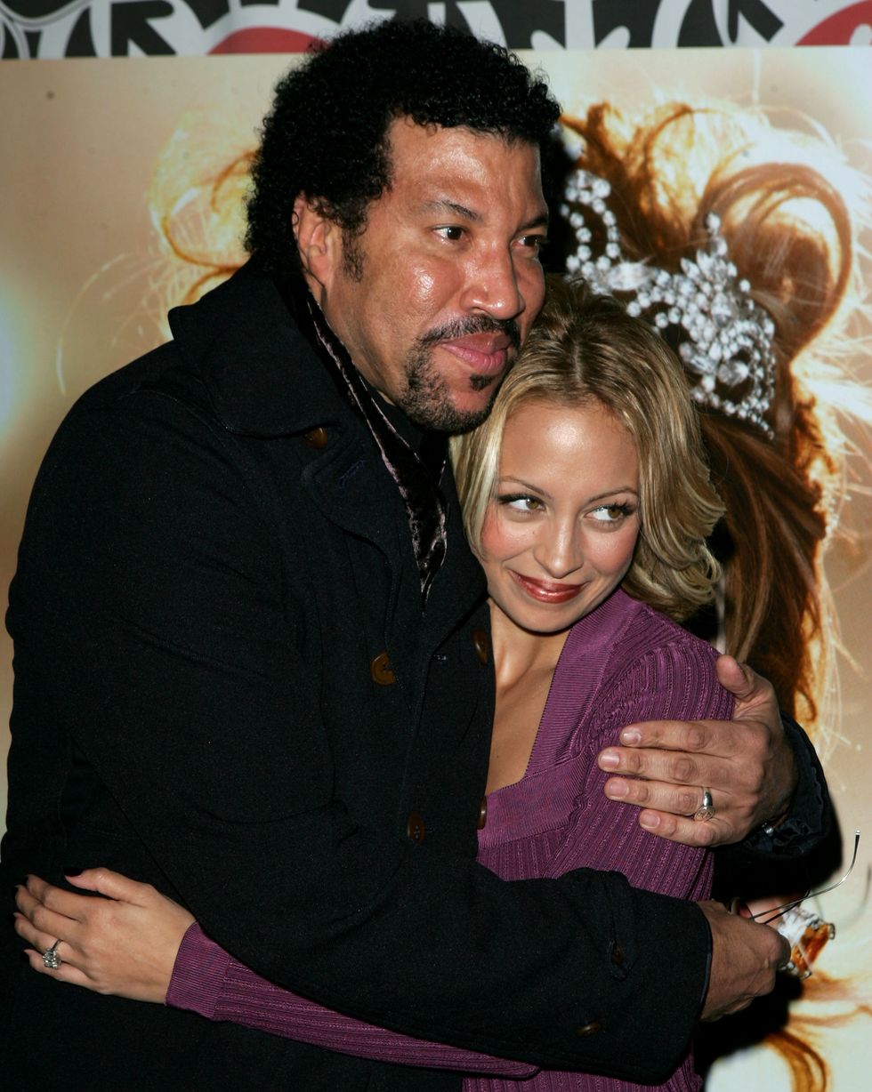 lionel richie and nicole richie hug and smile as they look away from the photo