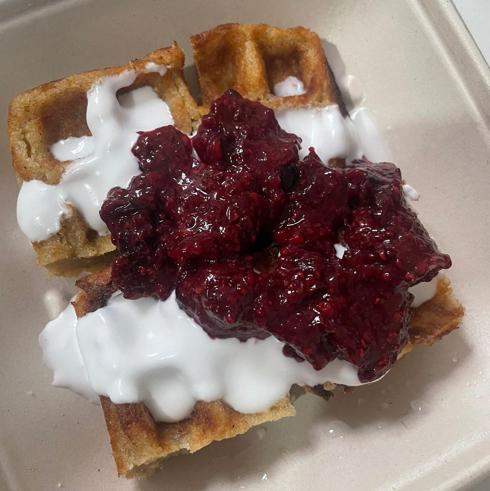 tasty looking waffles with berry compote and coconut cream