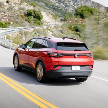 a red 2024 volkswagen id4 driving on a road