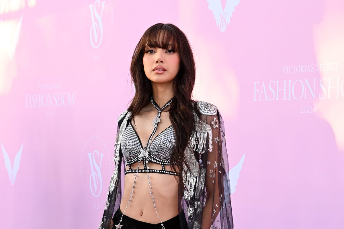 Lisa wears a bejeweled bra and cape to the Victoria’s Secret Fashion Show