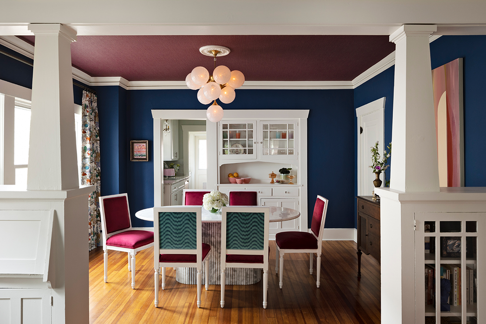 dining area with a round table stylish chairs and vibrant walls