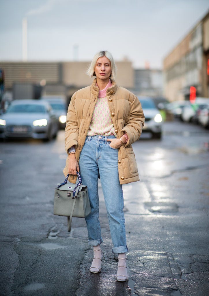 Lisa Hahnbueck wearing beanie, Louis Vuitton bag, blue orange