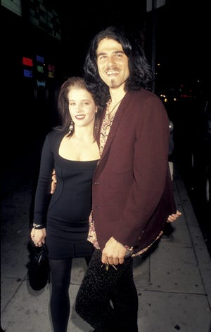 lisa marie presley and husband danny keough embracing and smiling for a photo