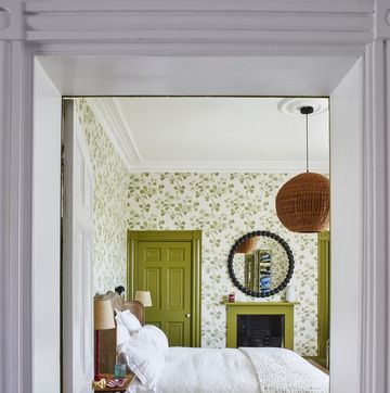 a bedroom with a mirror and a bed