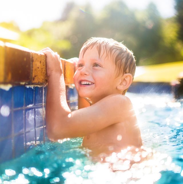 Little boy having fun in the swimming pool in summertime