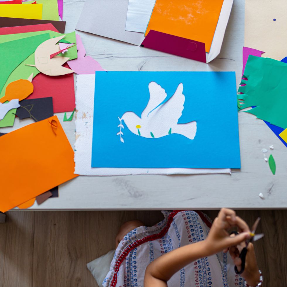 little girl cutting paper