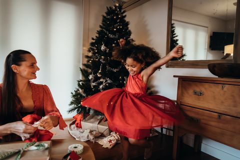 little girl dancing in red christmas eve dress