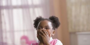 african american girl laughing, hands covering mouth
