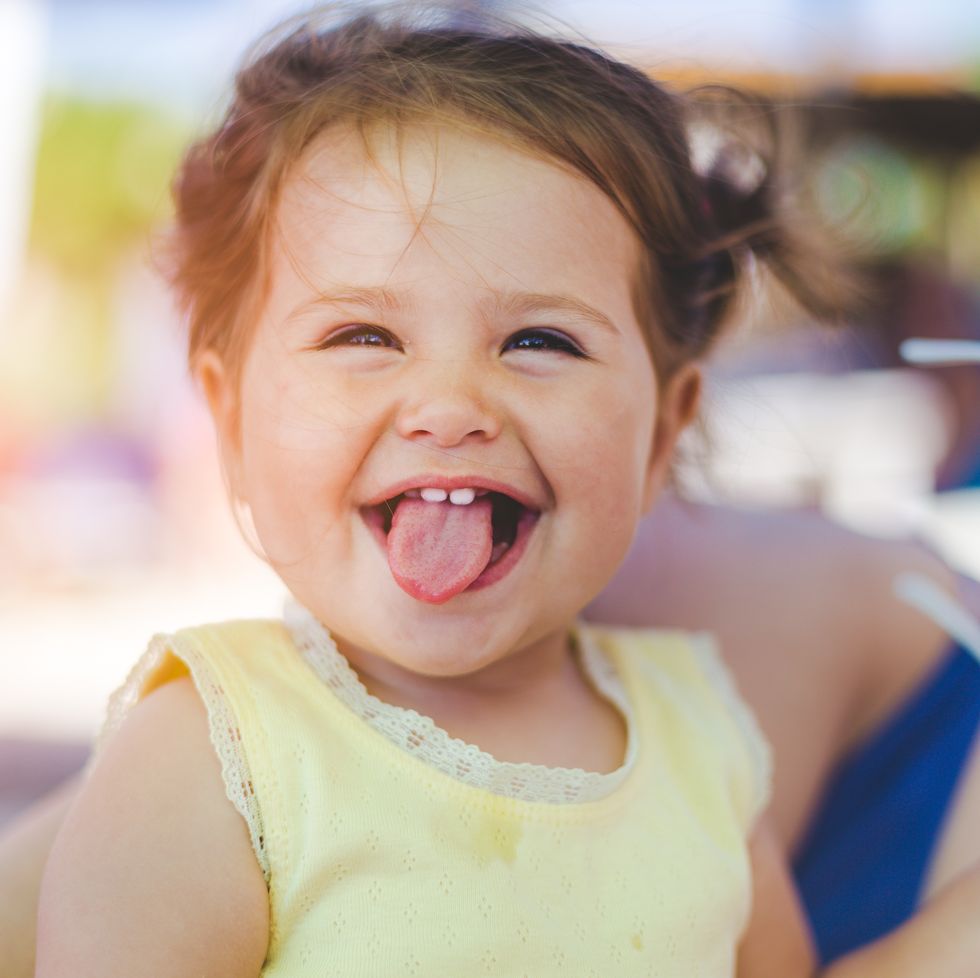 little girl sticking her tongue out