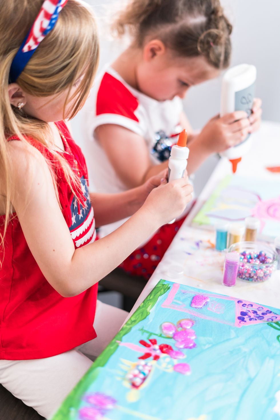 two little girls working on july 4th crafts