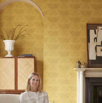 paint expert ruth mottershead sitting on a cream sofa in a yellow room