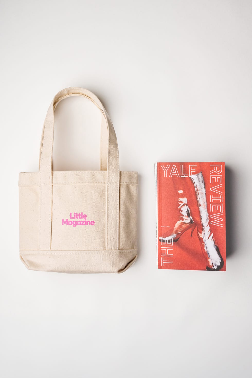 a mini tote bag reading 'little magazine' sitting alongside an issue of the yale review