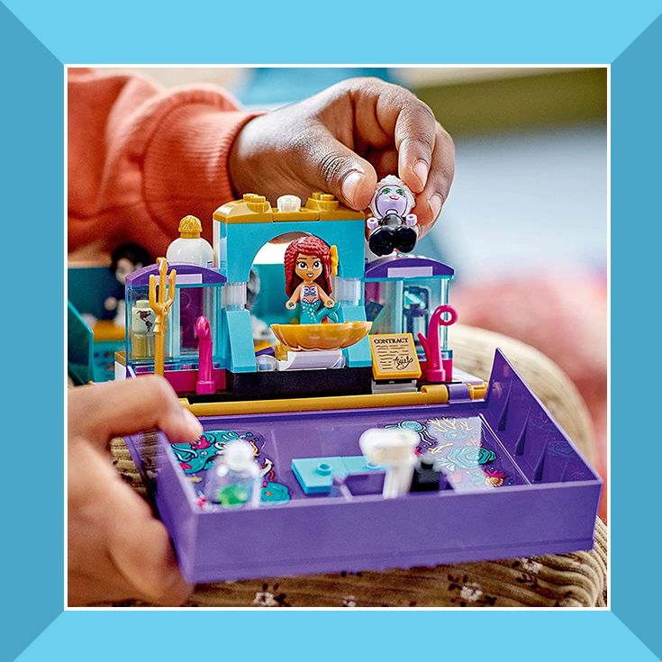 child playing with little mermaid lego playset
