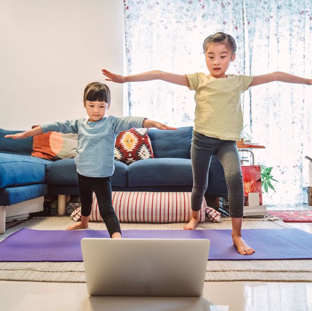 little sibling enjoy online yoga class with laptop computer at home