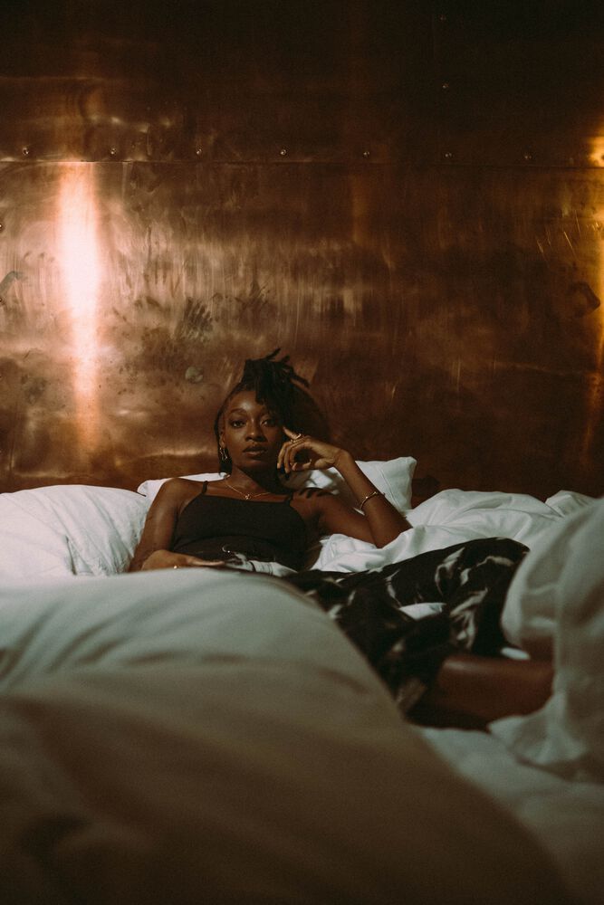 little simz album cover in a bed