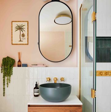 a cp hart bathroom with a round mirror and basin