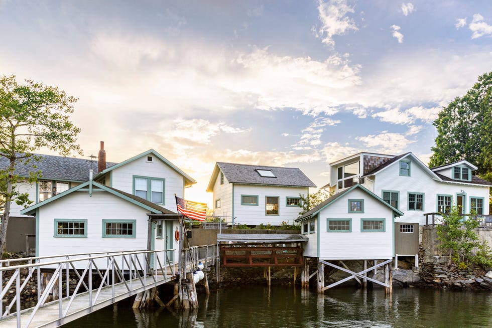 group of small white clapboard buildings built along the water