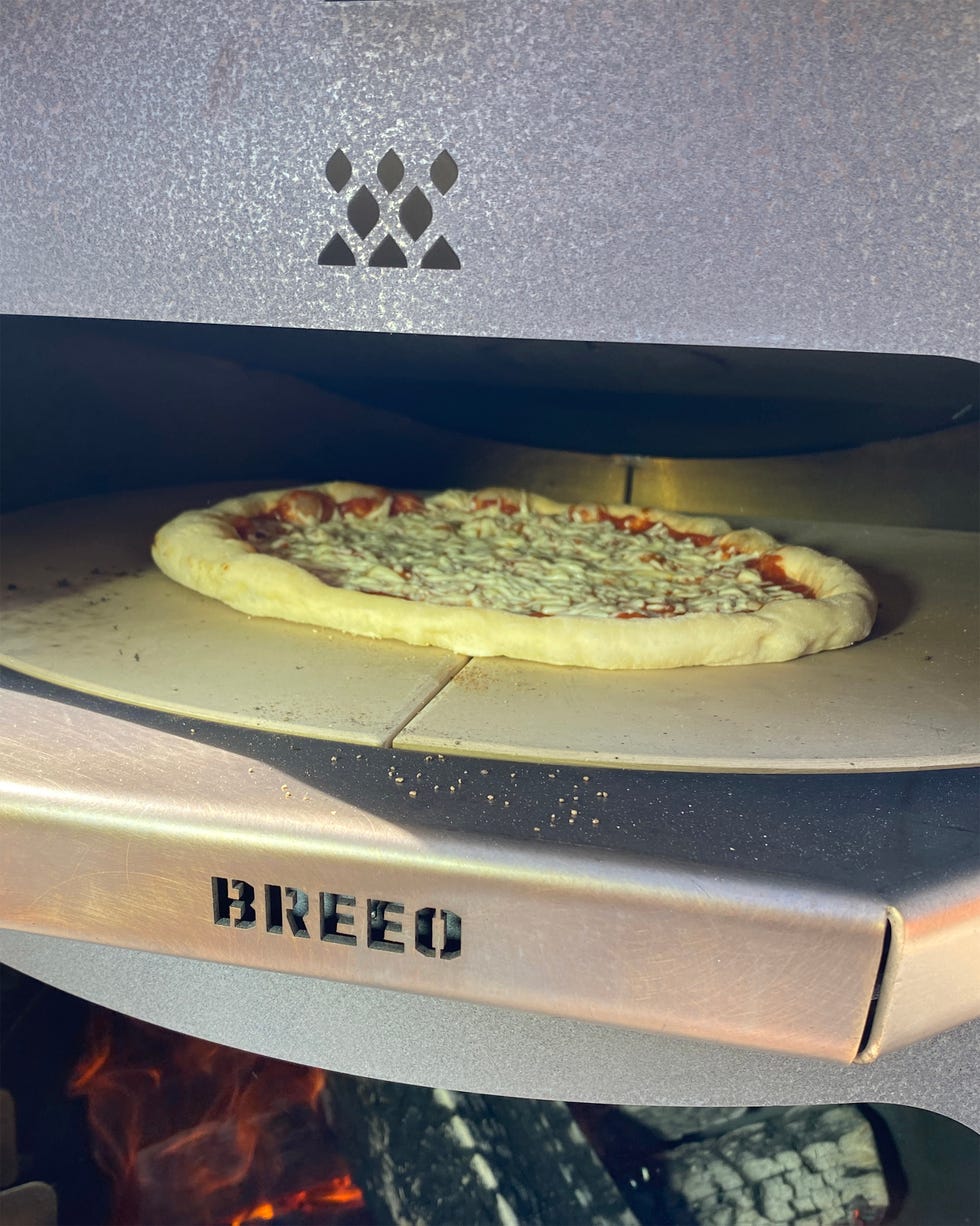 cooking pizza in a pizza oven