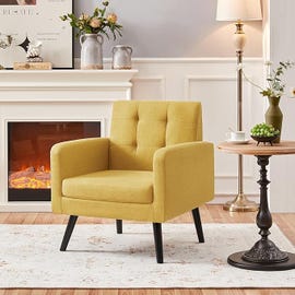 a yellow chair in front of a fireplace