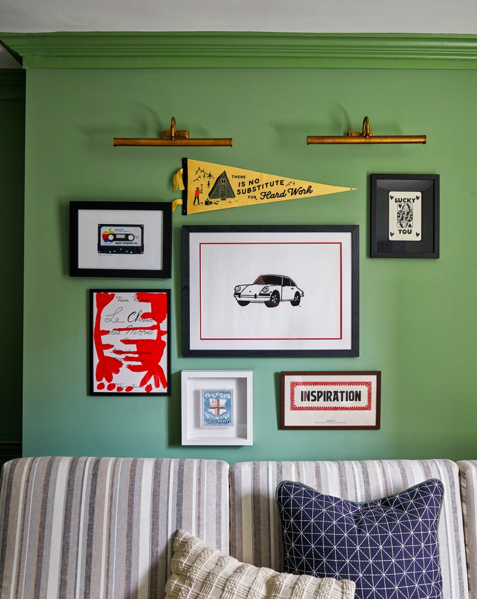 green gallery wall with framed items