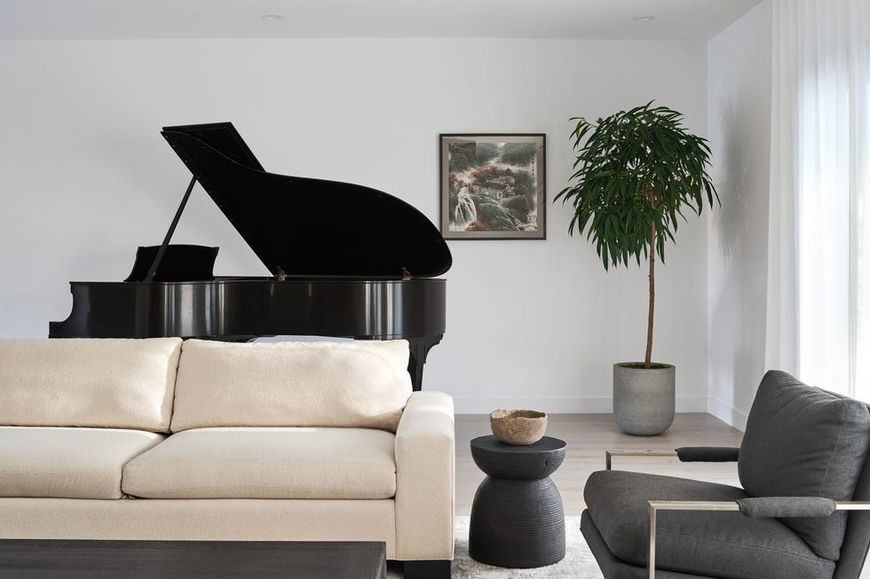 living room with white couch and piano