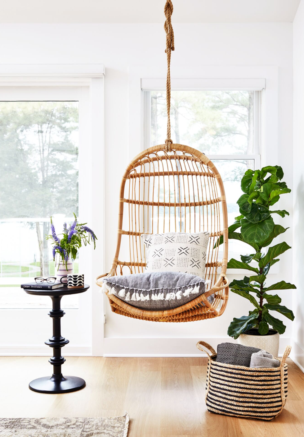 living room ideas rattan hanging chair in a white room with a narrow black table