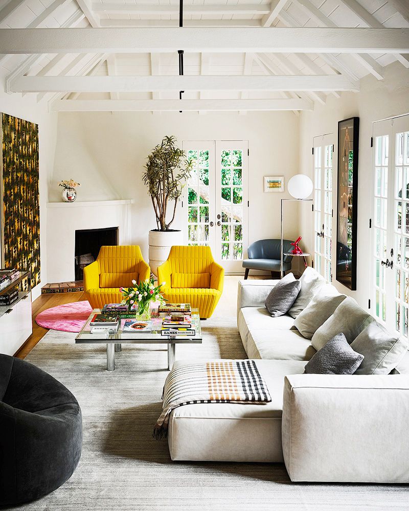 large white living room with yellow chairs and sectional