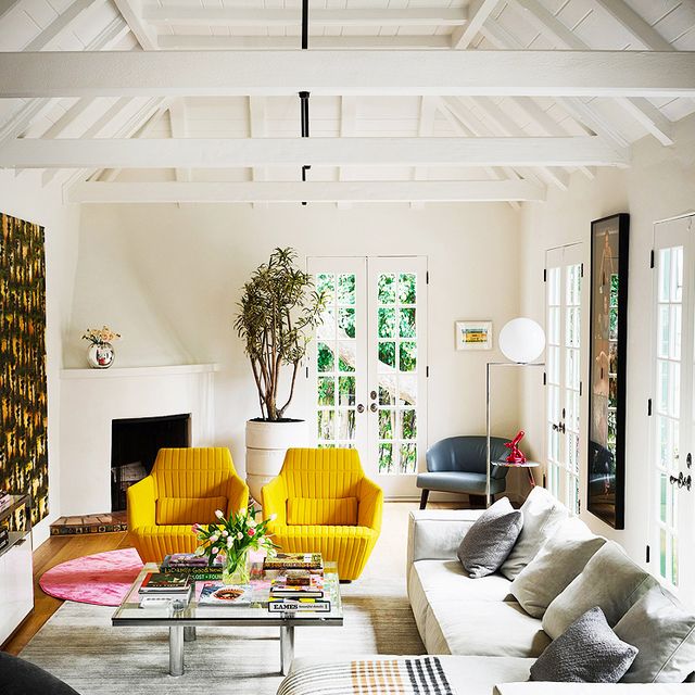 large white living room with yellow chairs and sectional