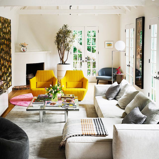 large white living room with yellow chairs and sectional