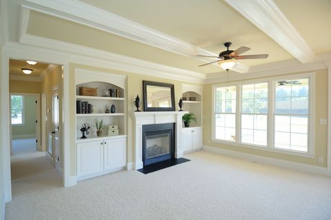 carpeted living room with fireplace