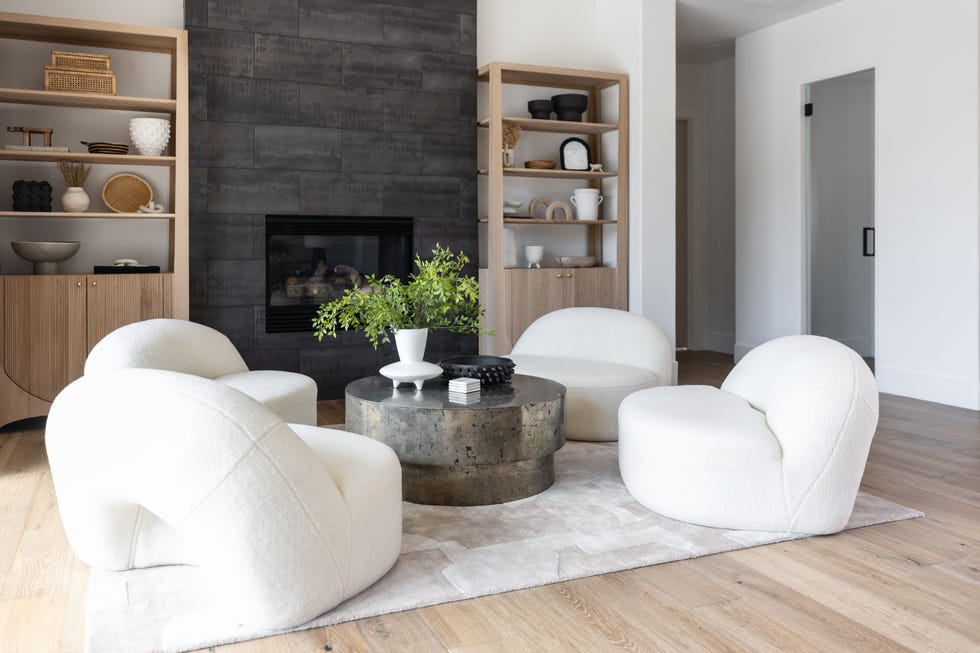 neutral living room with white curvy chairs