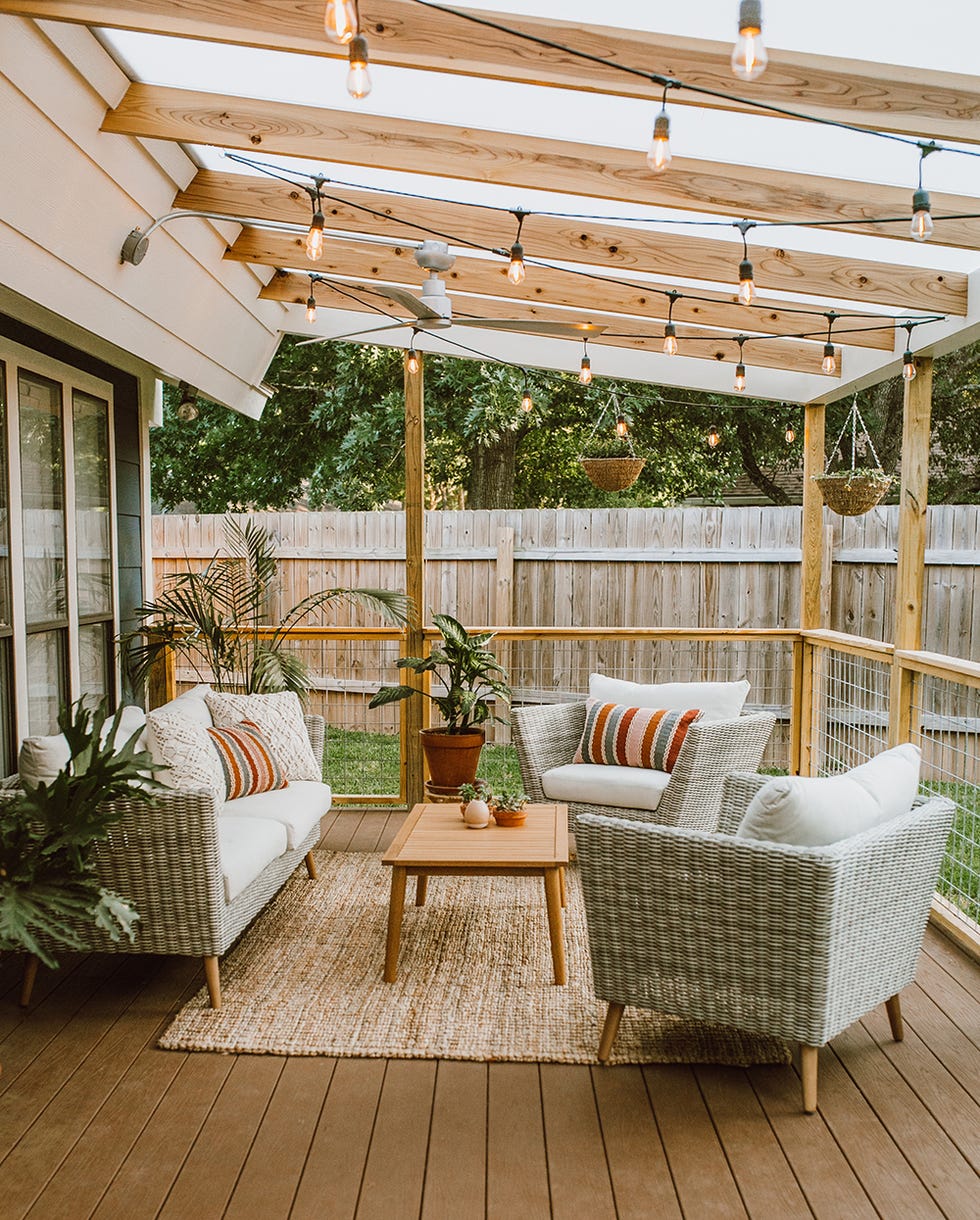 contemporary pergola over a raised patio in the backyard of a house