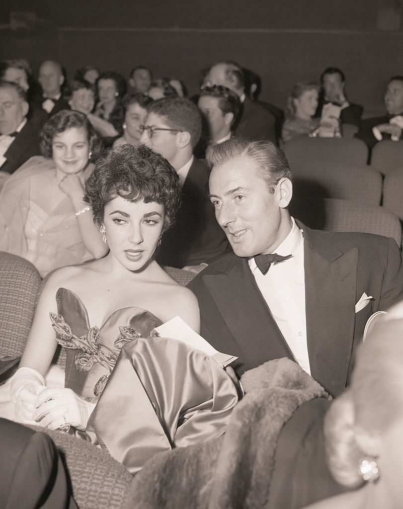 original caption 12141951 hollywood, ca  the newest hollywood romance to hold the interest of film fans is that of elizabeth taylor and michael wilding the romantic pair, pictured at a screenland premiere, are rumored to be considering an early marriage their dating, which began in england a short time ago, has continued steadily in new york and in movieville like the british born actor, liz, too, is a native of england, daughter of a well known stage actress sarah sothern one of englands best known stage and screen stars, wilding started his acting career as an extra