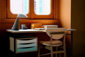 a wooden desk with coloured drawers