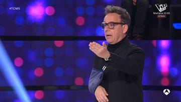 a person gesturing during a performance or show