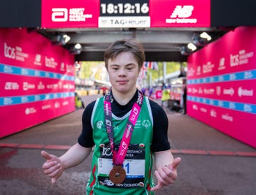 a runner poses for a portrait at the finish line of the london marathon