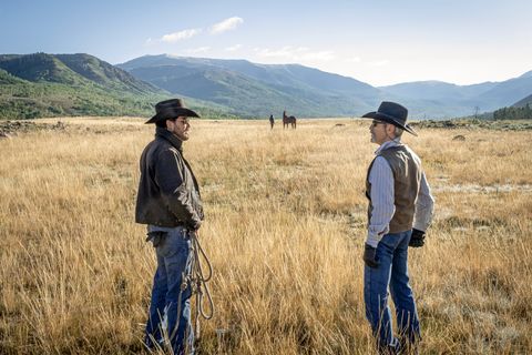 kevin costner and gil birmingham in yellowstone scene filmed in montana with mountains in background