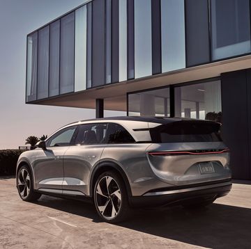 a lucid gravity suv parked outside a building