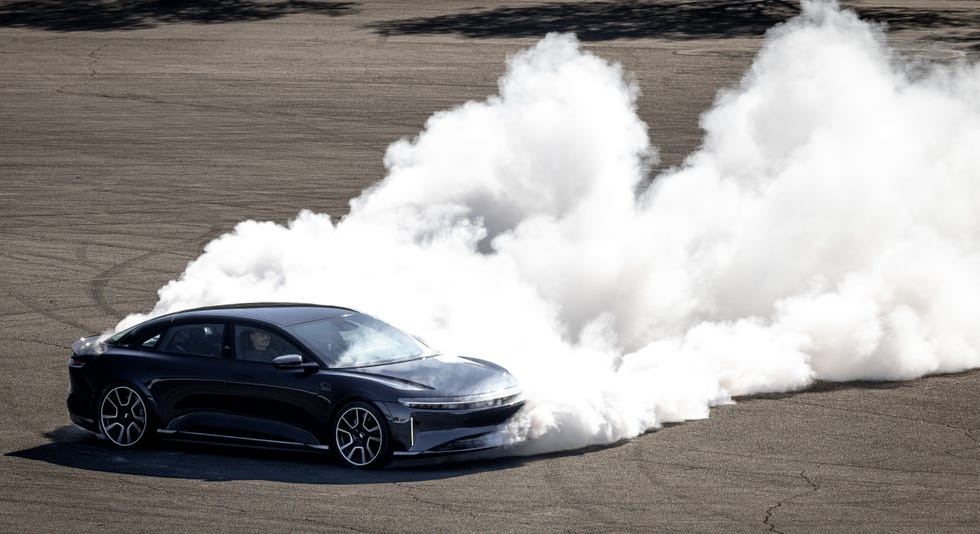 a car driving on a road with smoke coming out of it