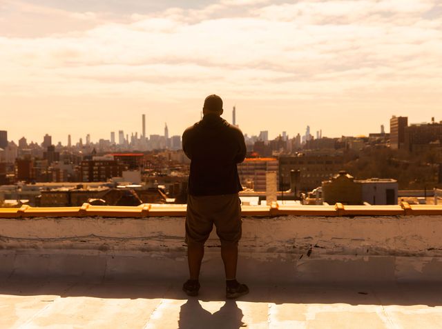 Jason Charles of the NYC Preppers Network stands on his roof in NYC, photographed in March 2020.