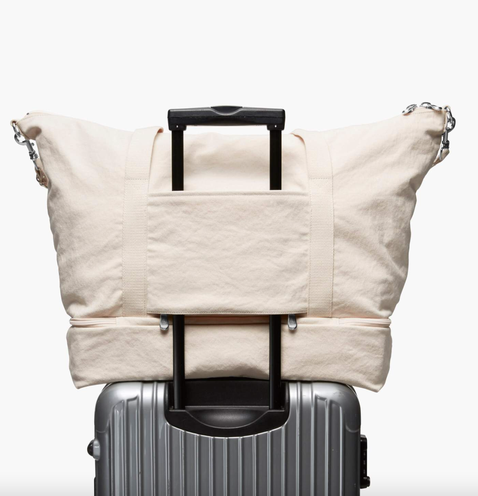lo and sons, white bag on top of a suitcase