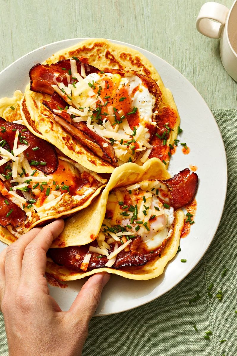 pancake tacos with eggs and bacon in the center