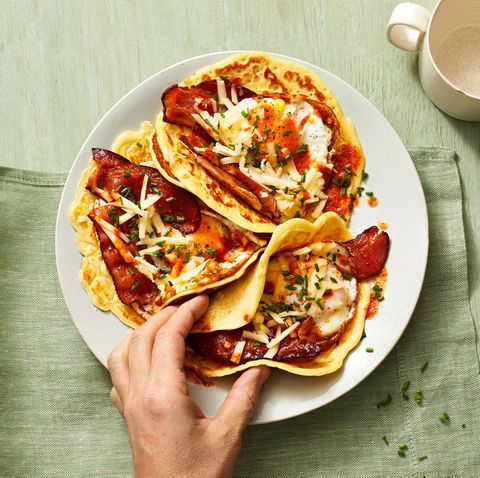 pancake tacos with eggs and bacon in the center