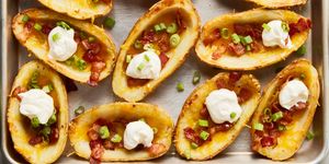 potato skins topped with bacon, chives, and sour cream dollops