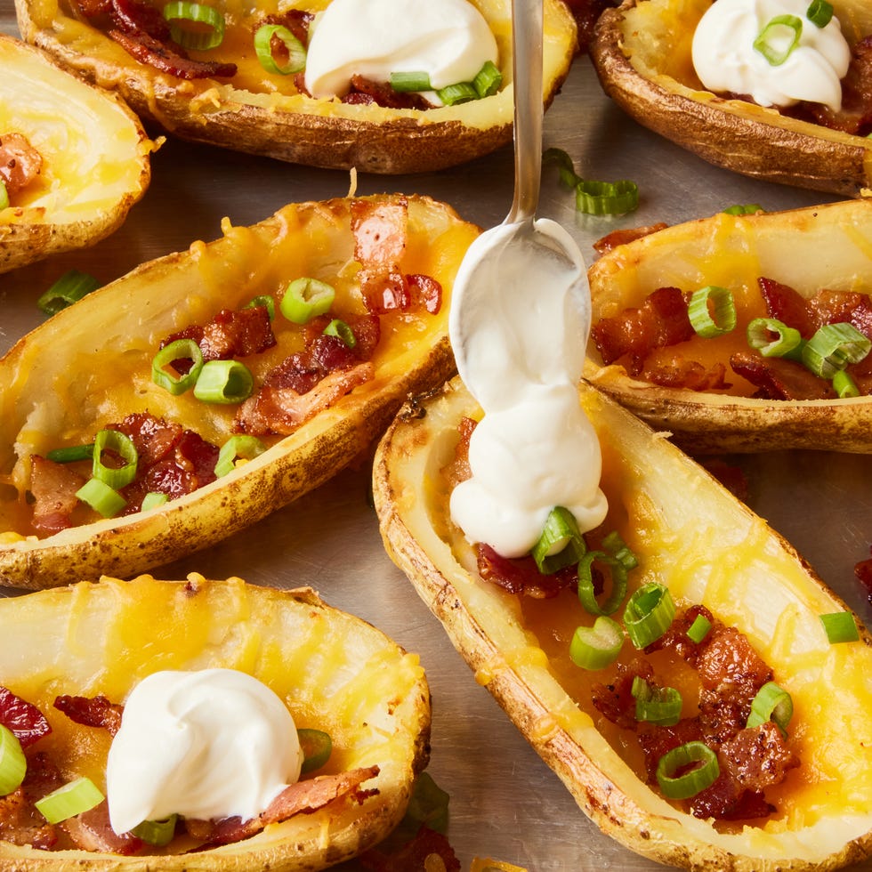 potato skins topped with bacon, chives, and sour cream dollops