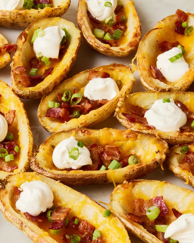 potato skins topped with bacon, chives, and sour cream dollops